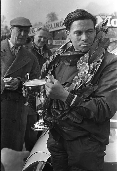 Jim Clark formula one motor racing driver April 1963 holding cup with laurel