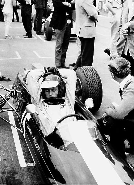 Jim Clark racing driver in car arms stretched over helmet 1965 Scottish World Champion