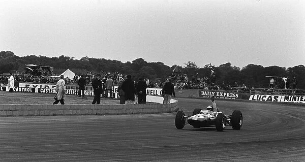 Jim Clark waves as he wins the British Grand Prix at Silverstone in 1965 in his Lotus
