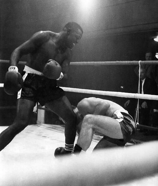 Jim Cooper goes down for a count of nine in the third round of his heavyweight fight