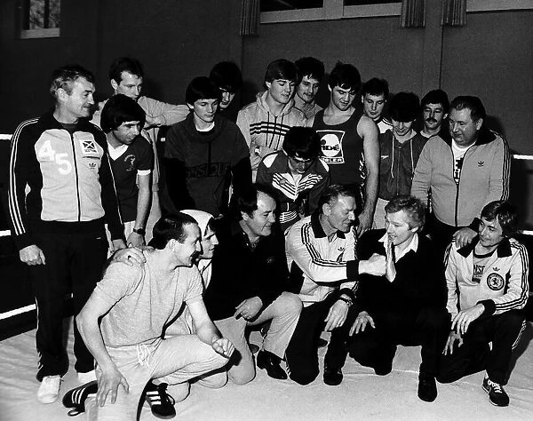 Jim watt playfully spars with Dick McTaggart as they and other boxers attend a training