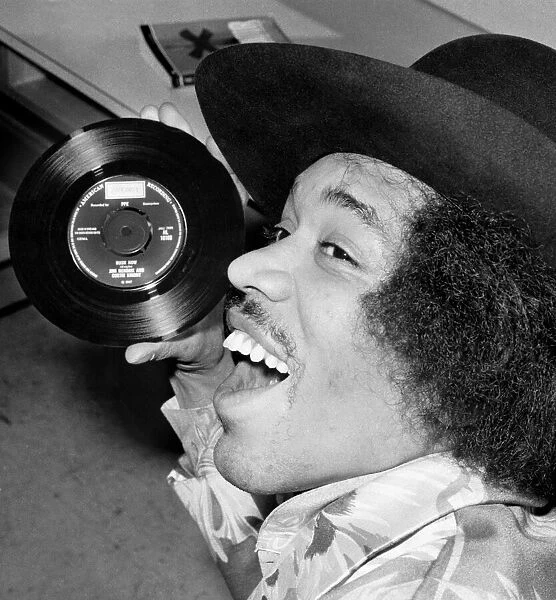 Jimi Hendrix with a copy of his new 7'release with Curtis Knight - Hush Now