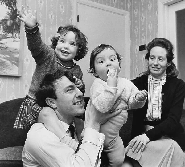 Jimmy Greaves plays with children Danny aged one and Mitzi, two. 31st January 1964