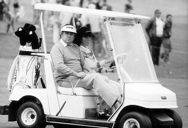 Jimmy Tarbuck takes a ride whilst out playing a game of golf in the a golf buggy