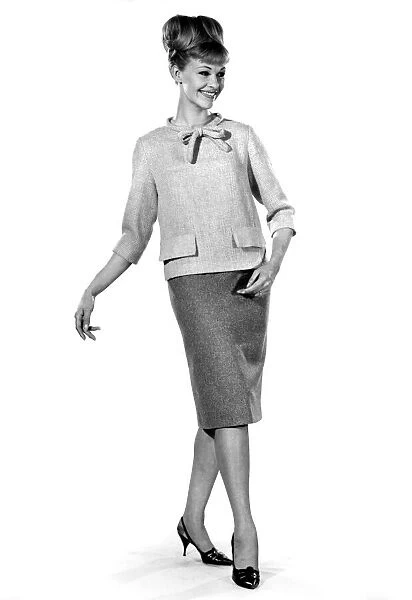 Jo Waring modeling a blouse and skirt ideal for the office. November 1964 P007534