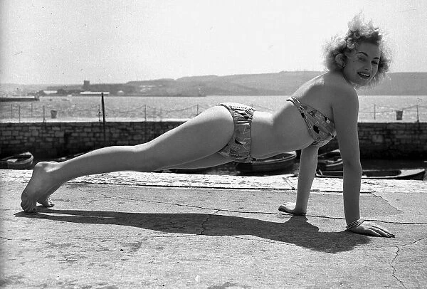 Joan Baxter 1957 showgirl doing keep fit press up on Plymouth harbour