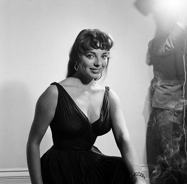 Joan Collins, actress, aged 22, pictured wearing black silk cocktail dress