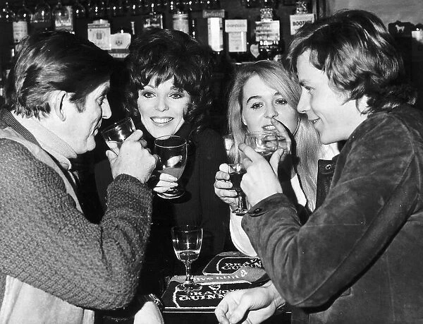 Joan Collins Actress enjoying a drink with Ray Barrett Sinead Cusack