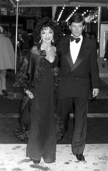 Joan Collins Actress walking arm in arm with her new man Malcolm Frazer