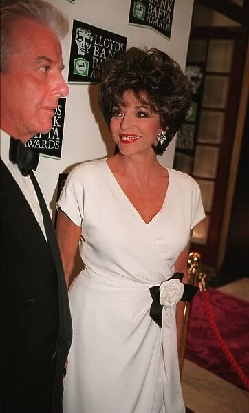 Joan Collins arriving BAFTA Awards 1996 accompanied by man wearing bow tie