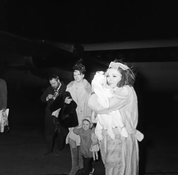 Framed Print : Joan Collins arriving by British European Airways from Paris with her daughter Tara