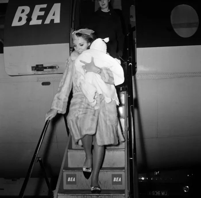 Framed Print : Joan Collins arriving by British European Airways from Paris with her daughter Tara