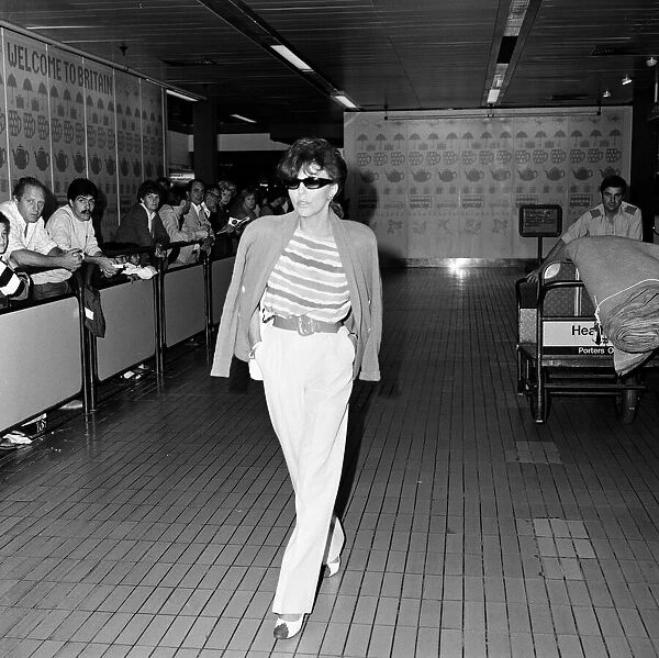 Joan Collins arriving at Heathrow from Los Angeles. 8th September 1983