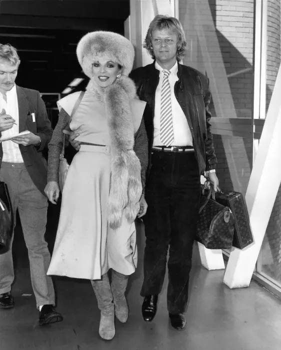 Framed Print : Joan Collins British Actress at Heathrow Airport with boyfriend Peter Holm in October