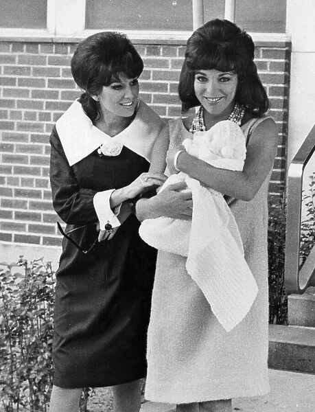 Joan Collins carrying baby daughter Tara with her sister Jackie Collins - 18th October