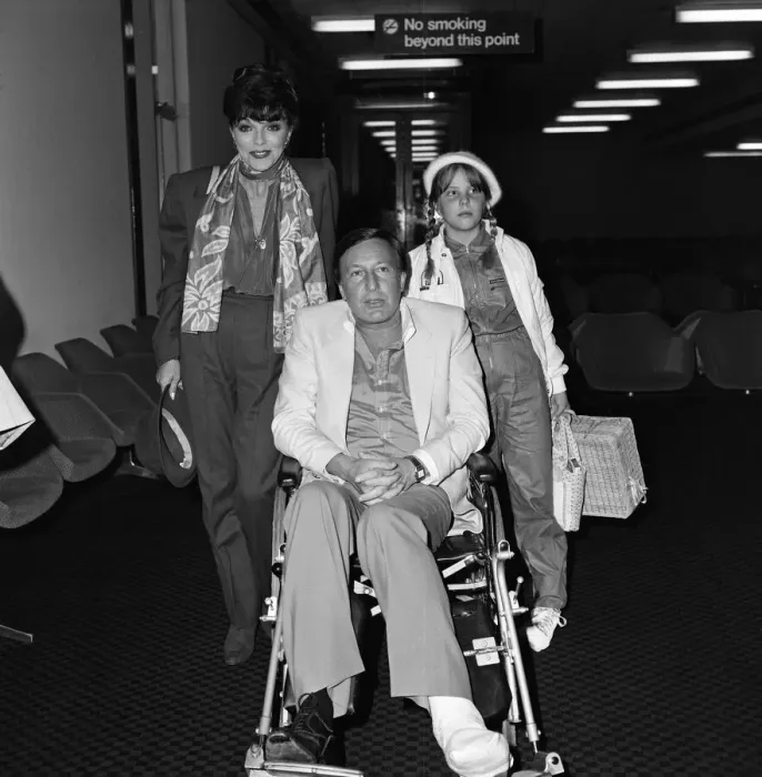 Framed Print : Joan Collins with husband Ron Kass and daughter Katyana arriving at Heathrow from Los