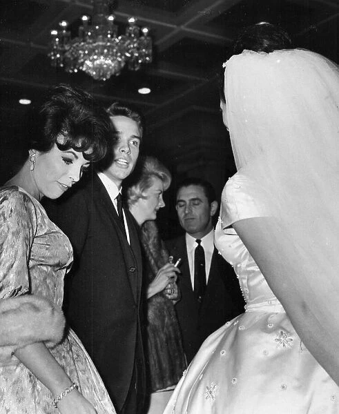 Joan Collins and Warren Beatty talking to Jackie Collins at her wedding - December 1960