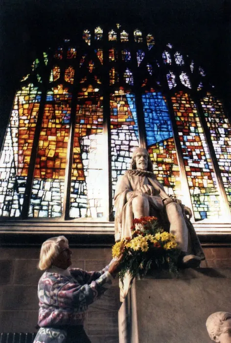 Framed Print : Joan Gage, of Stretford, puts flowers in front of one of the windows at Manchester