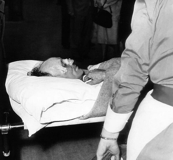 Jockey Arthur 'Scobie'Breasley arriving at a London Clinic on a stretcher