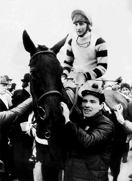 Jockey Phil Tuck on racehorse Burrough Hill Lad, being led into the winners enclosure