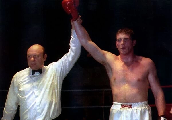 Joe Bugner Junior boxer after winning over Denroy Bryan Pictured with referee Dave Parris