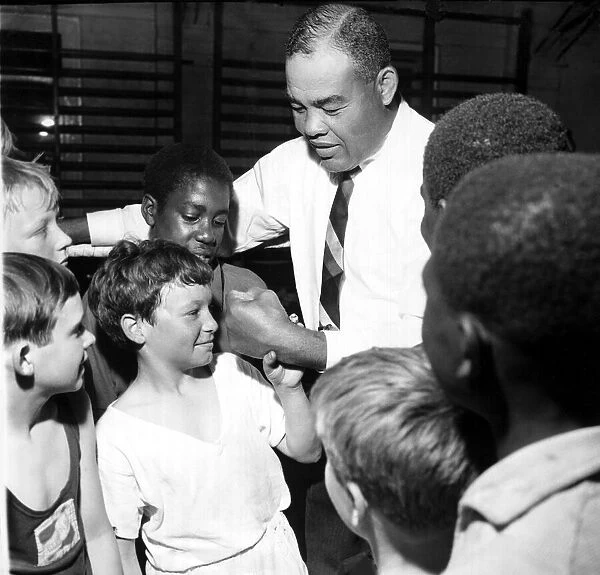 Joe Louis, former World Heavyweght Campion, visiting the gym at the Repton Youth Club in