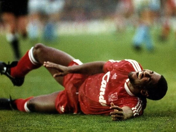 John Barnes Liverpool footballer collapses after he falls in pain from a hamstring injury