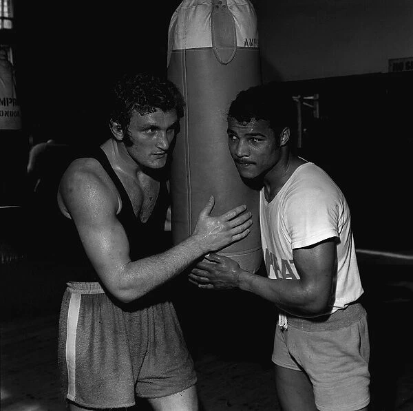 John Conteh and Joe Bugner in training by punch bag