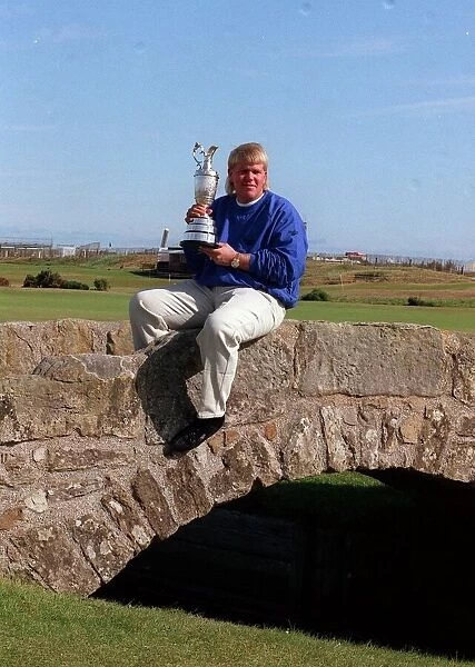 John Daly golfer Open Champion 1995 with trophy sitting on stone bridge