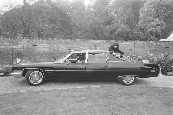 John Entwistle of the rock group The Who shows off his new car at the home of Keith Moon