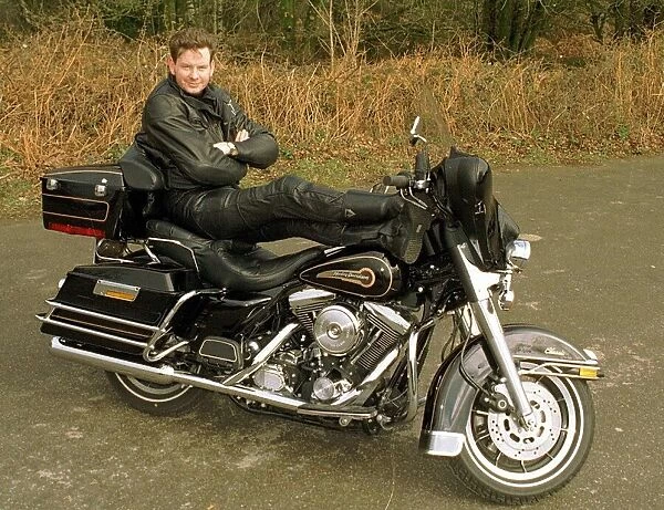 John Gordon Sinclair actor with his feet up on his Harley Davidson Electra Glide