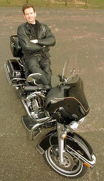 John Gordon Sinclair actor leaning back on his Harley Davidson Electra Glide motorcycle