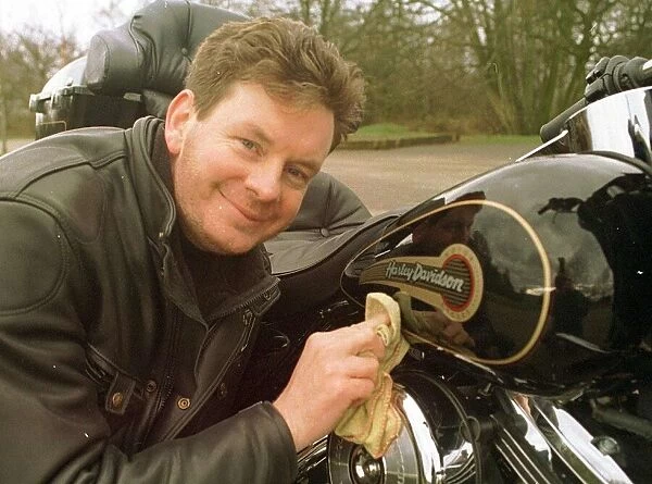 John Gordon Sinclair polishing his Harley Davidson March 1997