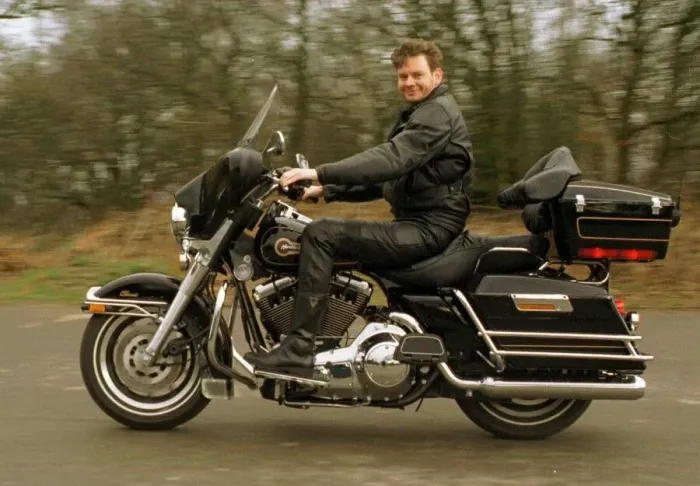 Framed Print : John Gordon Sinclair polishing his Harley Davidson Electra Glide motorbike March 1997