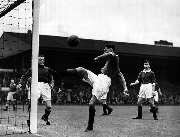 John Griffiths of Manchester United relieves pressure with an overhead clearance during