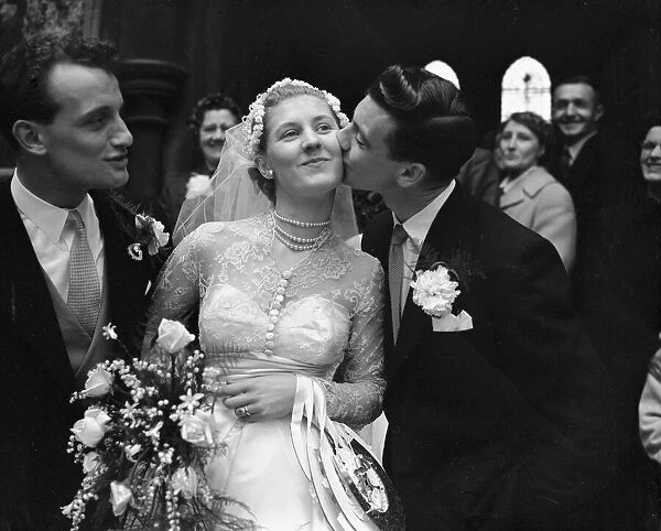 John Haynes, Fulham and England footballer (Right), kisses the bride the fomer Miss