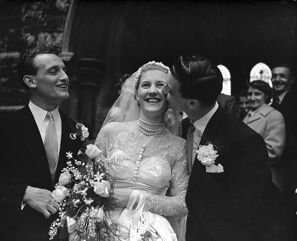 John Haynes, Fulham and England footballer (Right), kisses the bride the fomer Miss