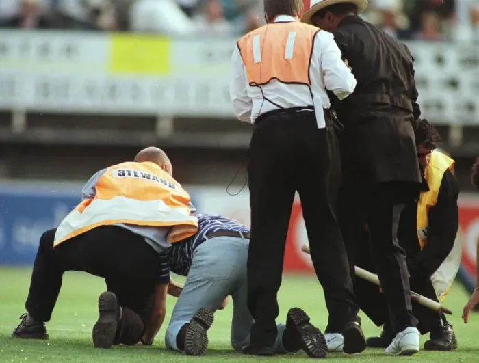 Framed Print : John Holder umpire is helped by steward after he was knocked to the ground by a fan