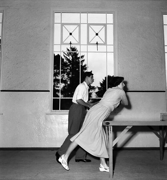 John Horn and Elaine Watson playing table tennis in their home. November 1952 C5457