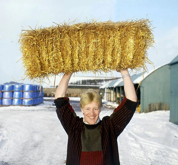 John Jeffrey holding haystack above head February 1986