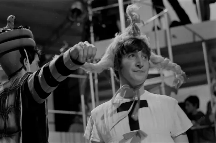 Framed Print : John Lennon from The Beatles rehearsing for the filming of