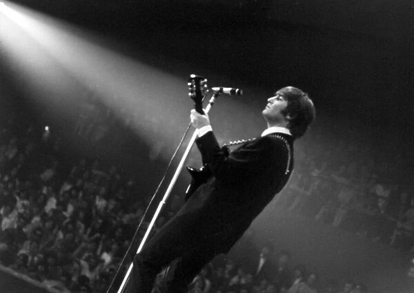 John Lennon of The Beatles on stage at the Palais des Sport in Paris. June 1964