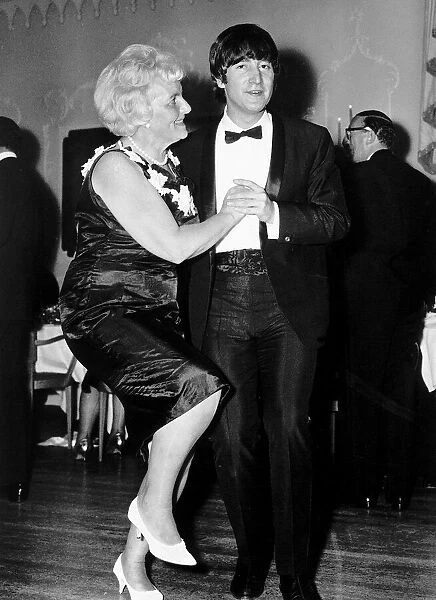 John Lennon dancing with Mrs Louise Harrison mother of George Harrison at the Dorchester