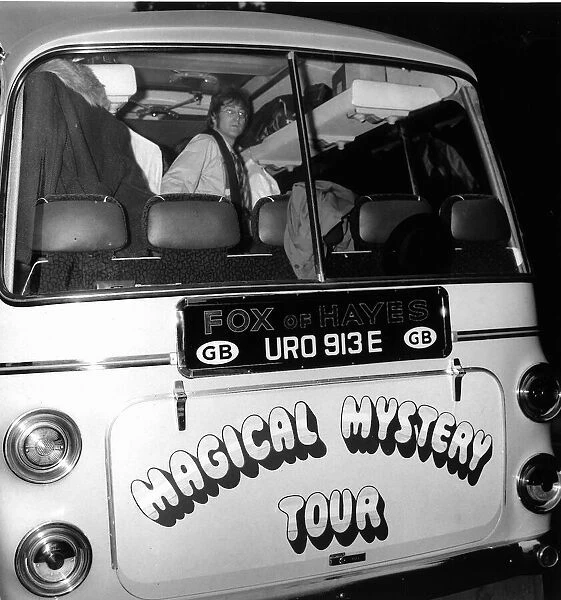 John lennon looks out of the back window of the Magical Mystery Tour Bus as The Beatles