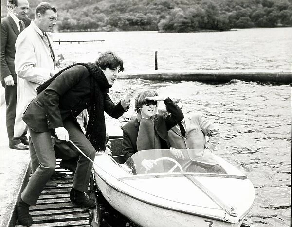 John Lennon and Paul McCartney of The Beatles pop group on a boat at their hideaway in St
