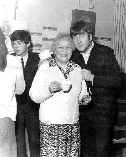 John Lennon poses with this lady who is having a cuppa back stage at the Coventry Theatre