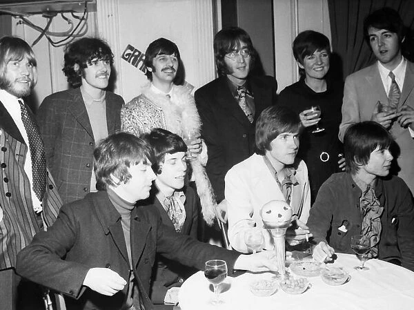 John Lennon and Ringo Starr of The Beatles (back row centre