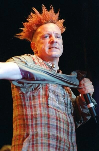 John Lydon of Sex Pistols pop group at SECC Glasgow tearing off sleeve