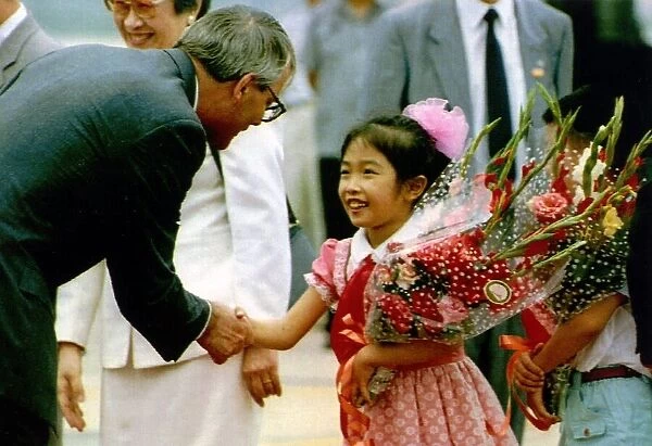 John Major is presented with flowers during his visit to China 1991
