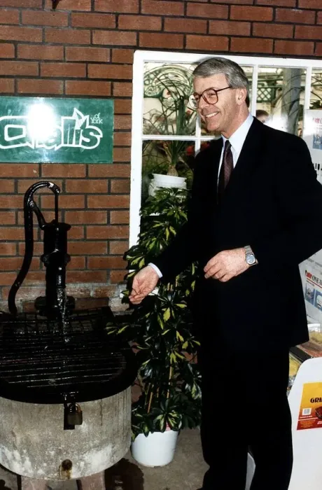 Framed Print : John Major Prime Minister throwing money into a wishing well during the 1992 election Framed Print : John Major Prime Minister throwing money into a wishing well during the 1992 election